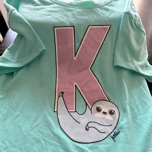 The letter”K” lunch box and shirt.